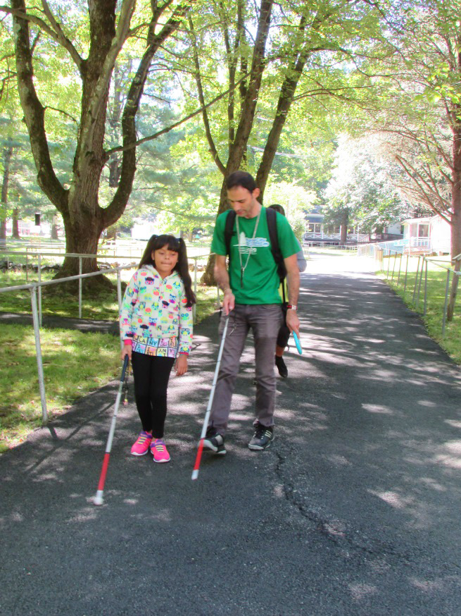 Man and girl walking in park with canes