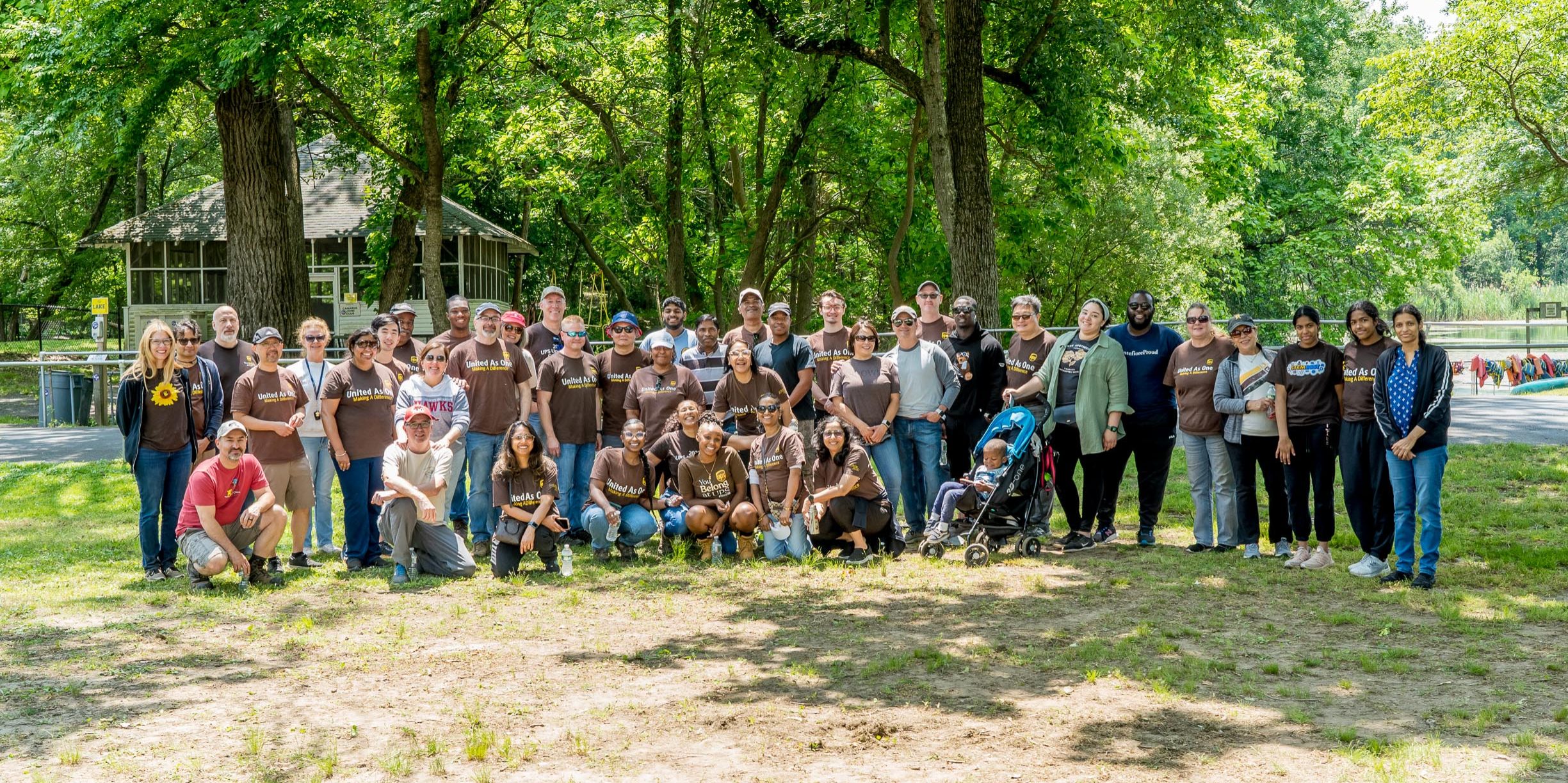 Large group photo of volunteers and staff standing together and smiling to the camera.