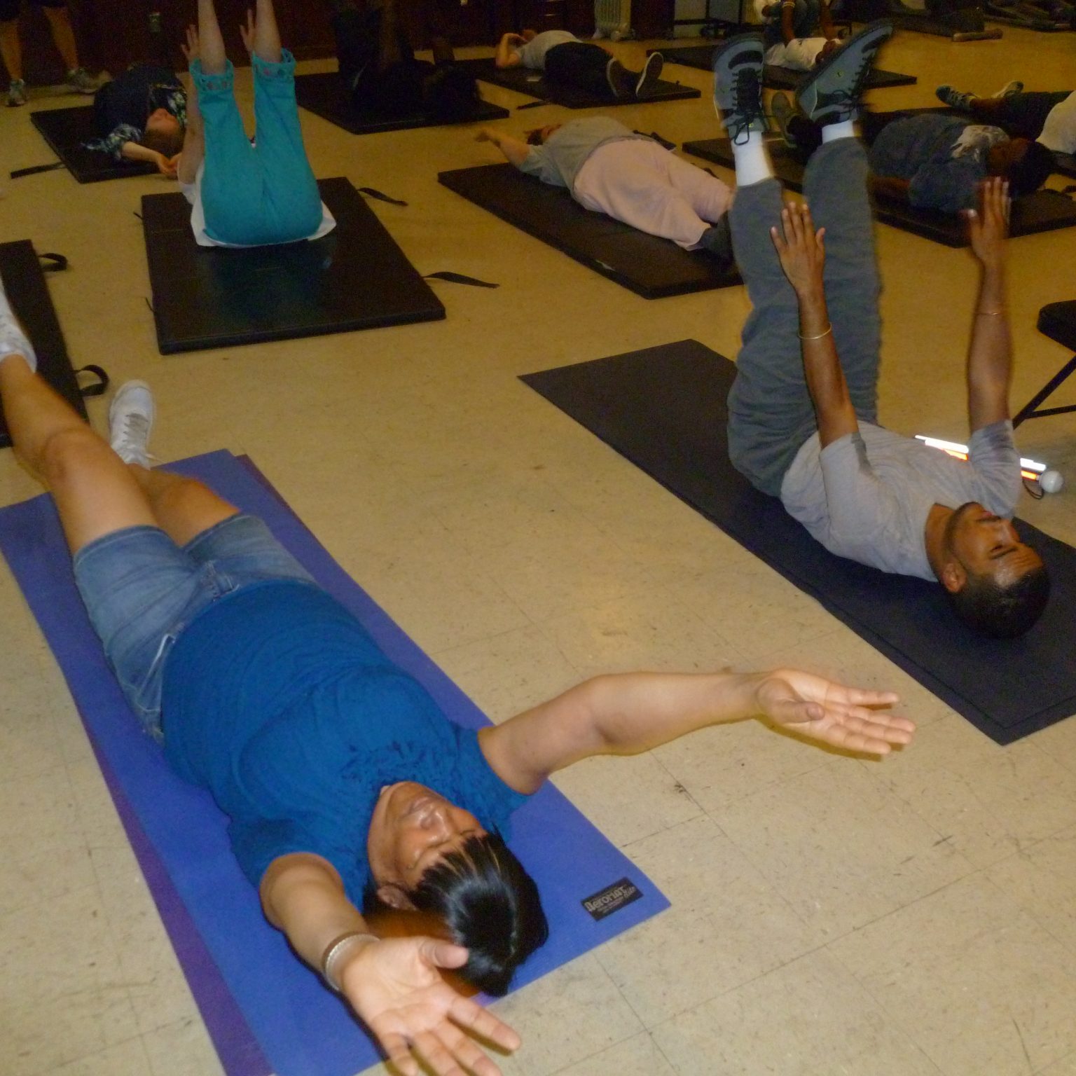 Fitness Explosion Class - people doing ab workouts on mats