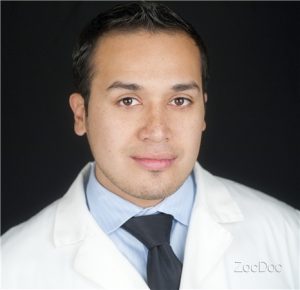 Image of Vincente Calderon wearing a white suit, smiling to the camera.