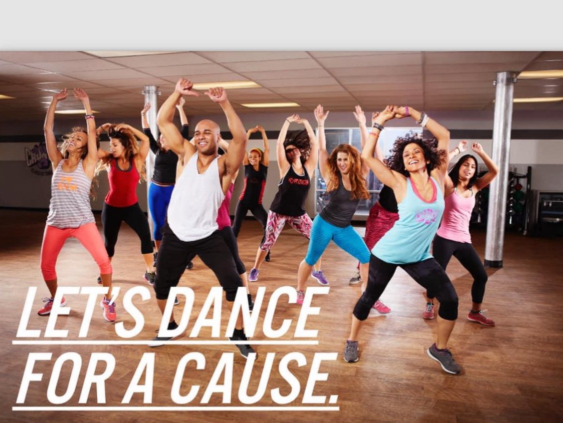Let's Dance For a Cause. Photo of a group of dancers with their hands in the air as they move their hips.