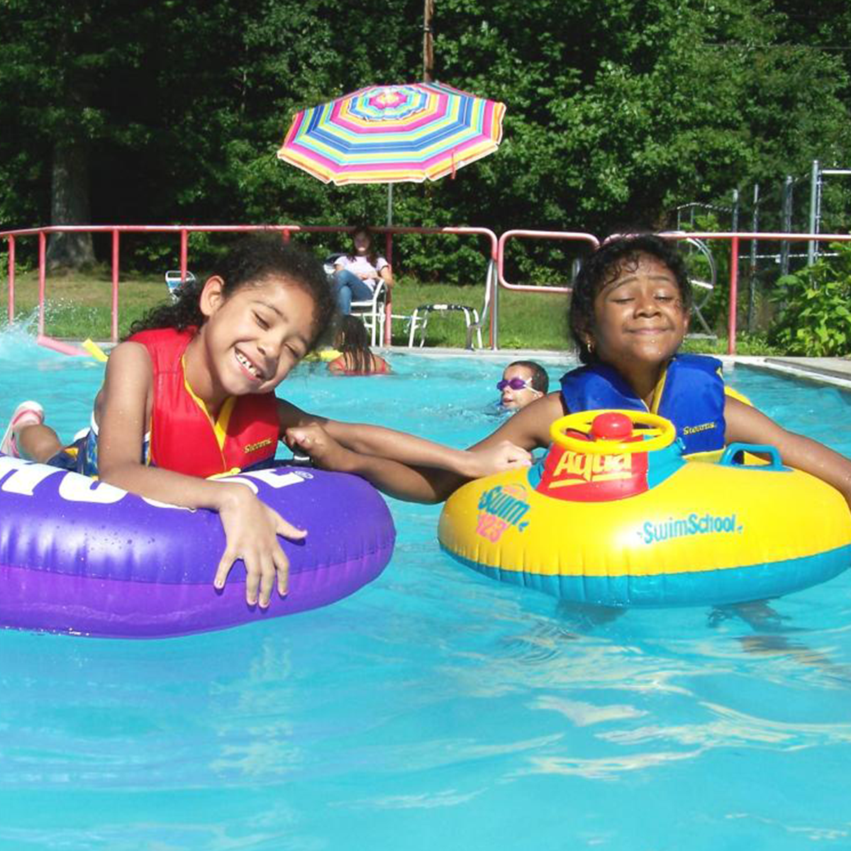 Girls in inner-tubes in pool